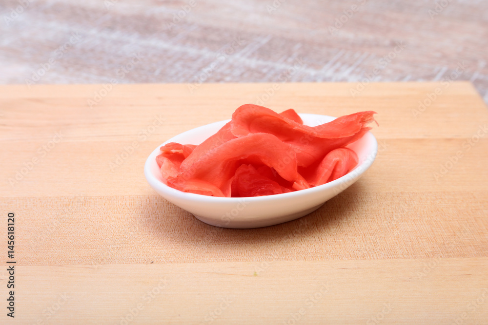 plate with Japanese pickled ginge on wood background. plate with Japanese pickled ginge on wood background.