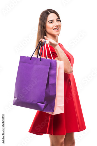 Beautiful woman with color shoping bags in hands on white background