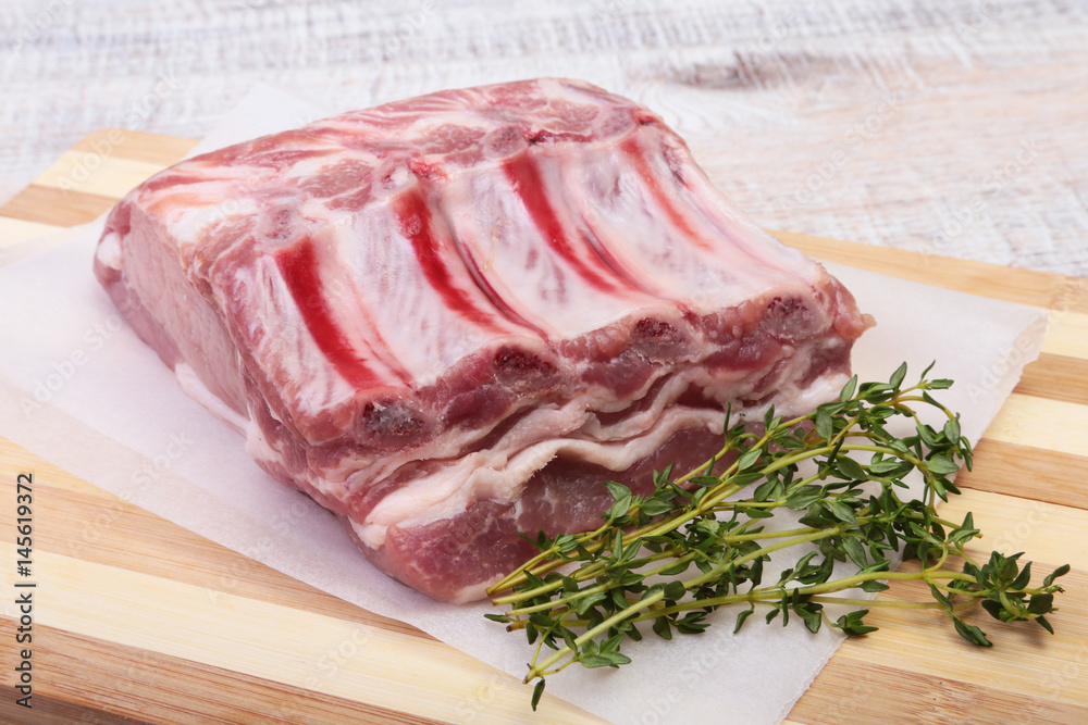 Raw pork chops, spices and rosemary on cutting board. Ready for cooking. Raw pork chops, spices and rosemary on cutting board. Ready for cooking.