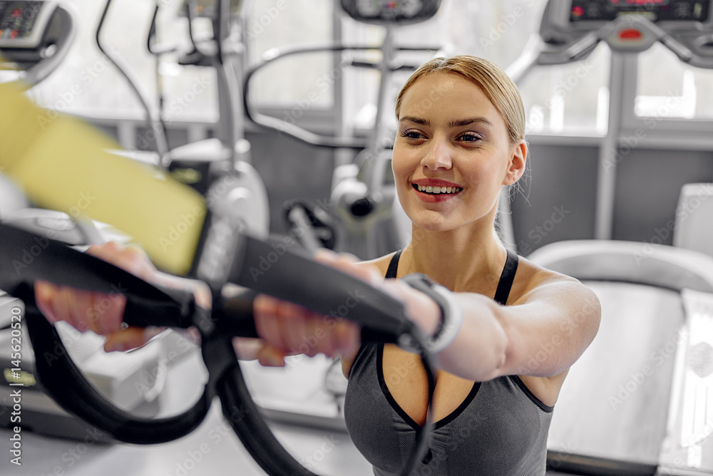 Cheerful female working out in fitness center Cheerful female working out in fitness center