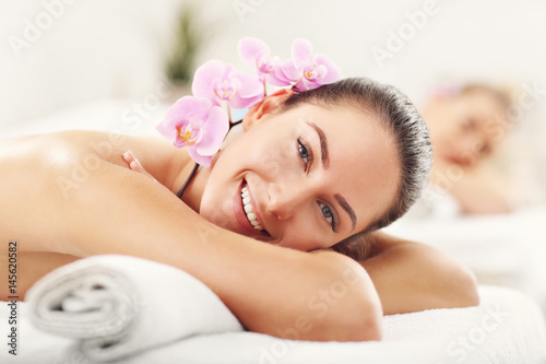 Two beautiful women getting massage in spa