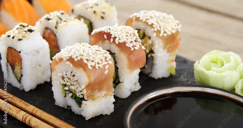 Set of assorted sushi served on black stone slate Set of assorted sushi served on black stone slate