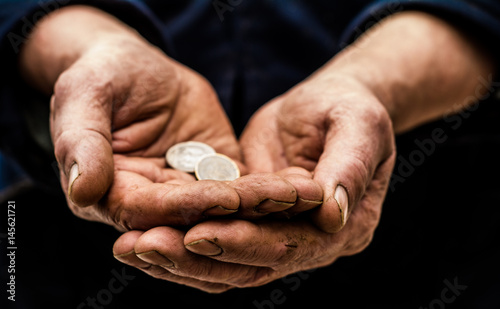 In the hands of man are different metal coins. 