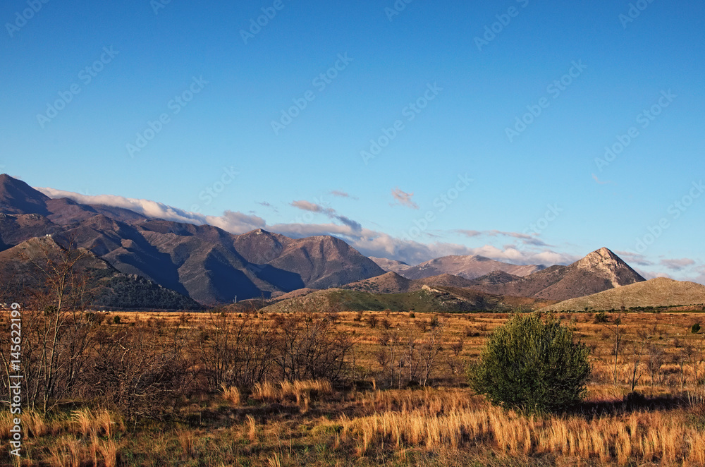 Beautiful morning landscape with mountains on a background of blue sky. Italy