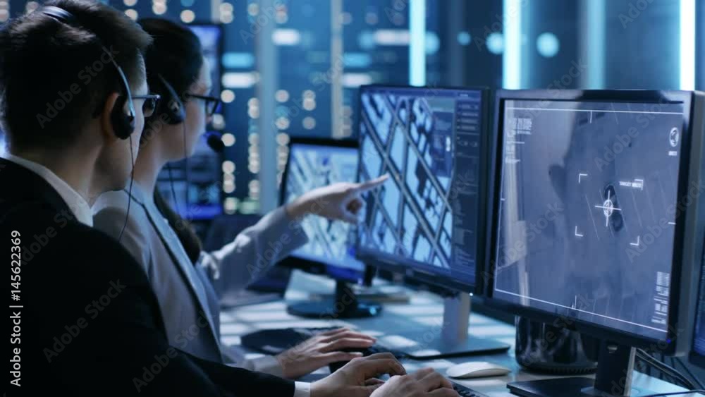 In Government Agency System Surveillance Center Employees Trace Criminal with Help of GPS. Their Room is Full of Displays with Various Data on Them.Shot on RED EPIC-W 8K Helium Cinema Camera.