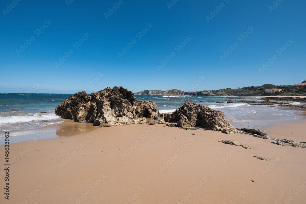 Scenic beach in the touristic village of Comillas, Cantabria, Spain.