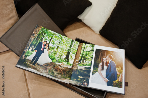Open pages of brown luxury leather wedding book or album.