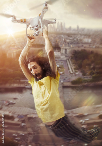 Conceptual portrait of a man flying with a drone
