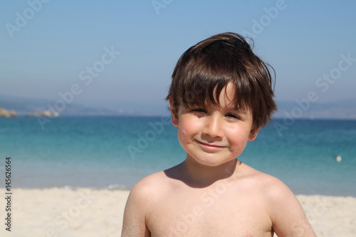 portrait of a kid in the beach at sunset