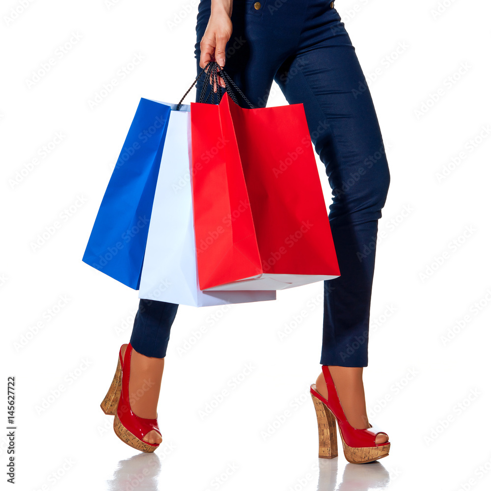 Closeup on fashion-monger walking with shopping bags on white