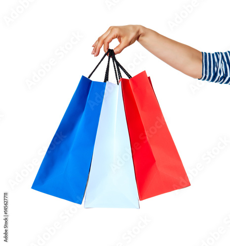 Closeup on hands with shopping bags on white background