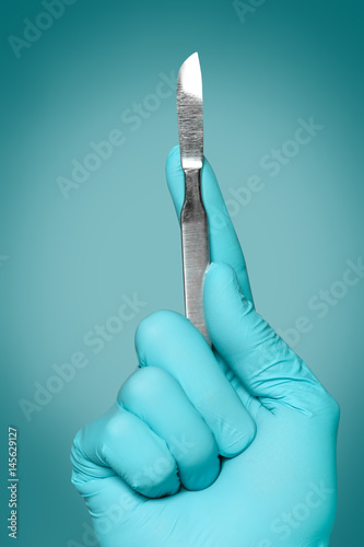 Obraz na plátne Hand of doctor with lancet on grey background