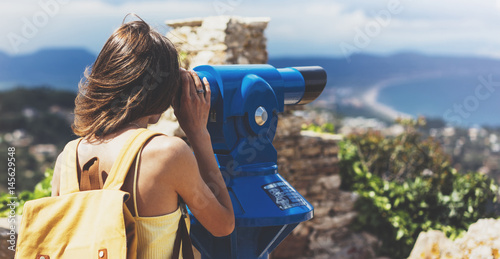 Hipster tourist look observant binoculars telescope on panoramic view, lifestyle concept trip, traveler with backpack on background mountain and blue sea landscape horizon, young girl hiker
