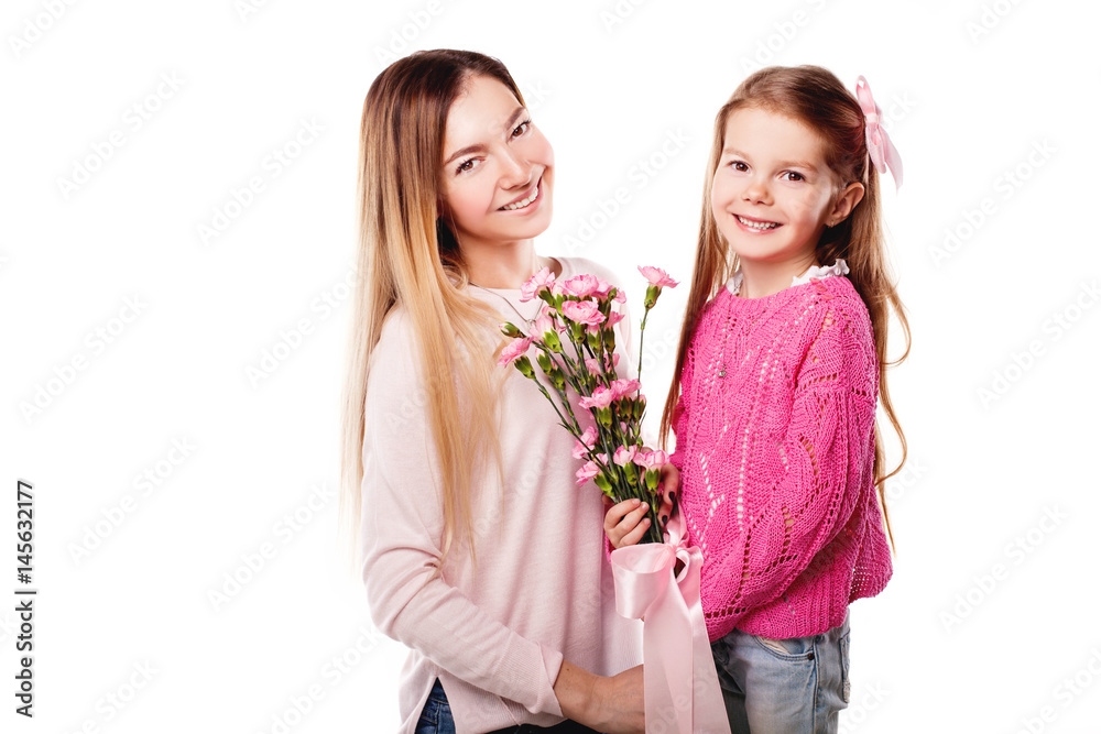 Portrait of happy smiling mother and daughter with bouquet of pink carnations and gift with pink ribbon isolated on white. Happy family. Happy mother's day. Mothers day card. Portrait of happy smiling mother and daughter with bouquet of pink carnations and gift with pink ribbon isolated on white. Happy family. Happy mother's day. Mothers day card.