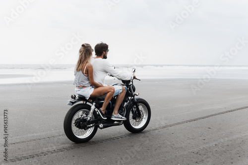 Young beautiful couple riding motorcycle