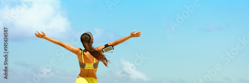 Fitness healthy lifestyle running woman banner panorama. Freedom happiness sporty girl with open arms in success on blue sky copy space.