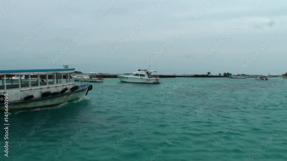Yachts and boats on the background of water and coast in the Maldives. Pleasant journey into the world of beautiful nice nature. A unique landscape. Yachts and boats on the background of water and coast in the Maldives. Pleasant journey into the world of beautiful nice nature. A unique landscape.