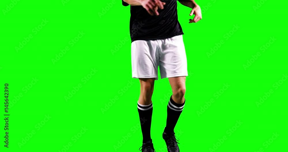 Athlete practicing soccer against green screen Athlete practicing soccer against green screen