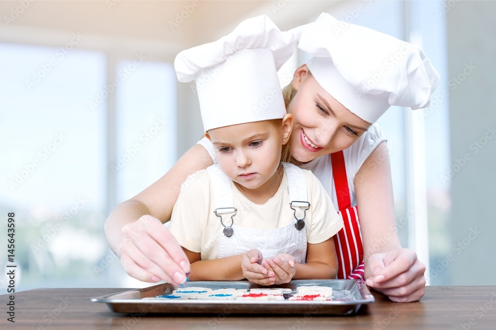 Woman and child cooking. Woman and child cooking.