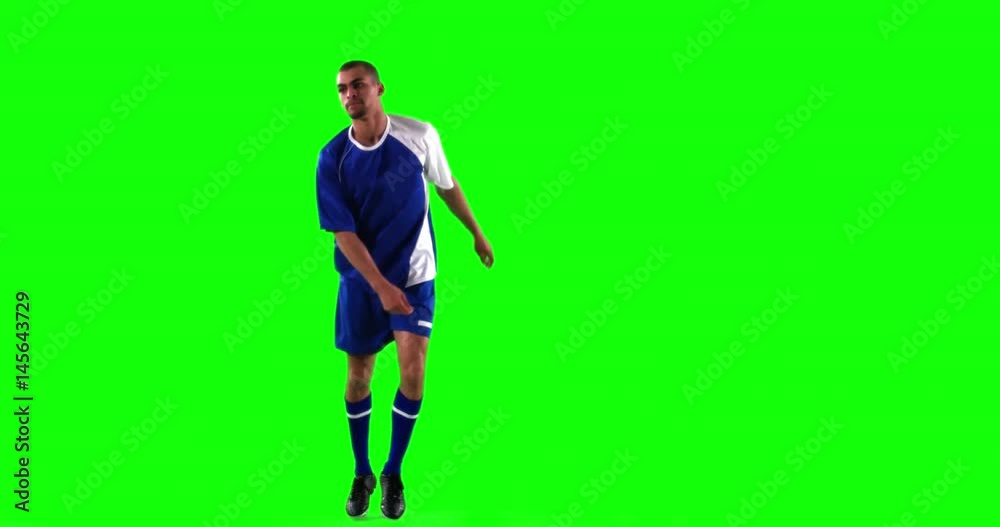 Athlete practicing soccer against green screen Athlete practicing soccer against green screen
