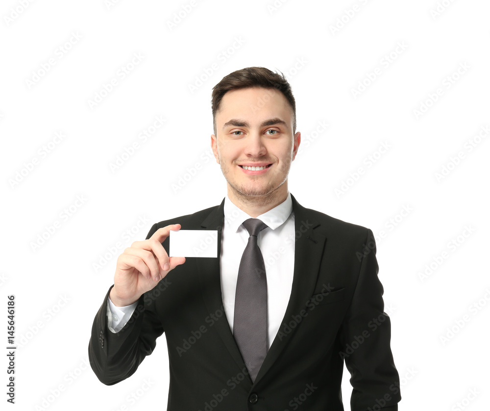Handsome young man with business card on white background