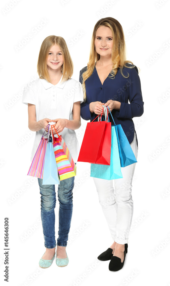 Mother and daughter with paper bags on white background