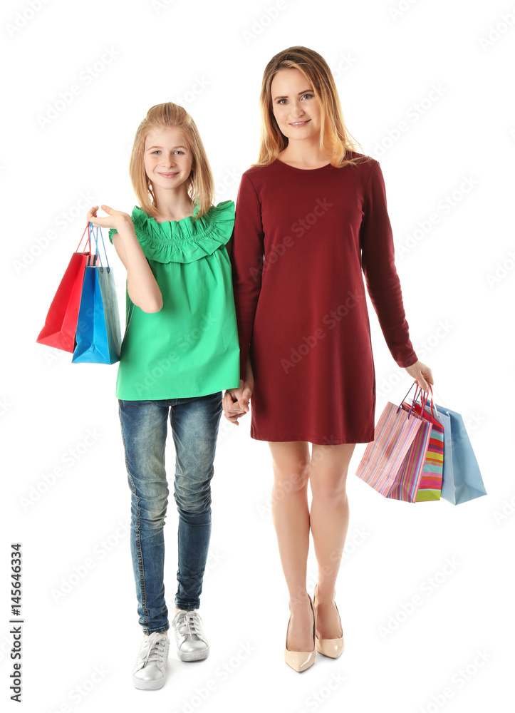 Mother and daughter with paper bags on white background Mother and daughter with paper bags on white background