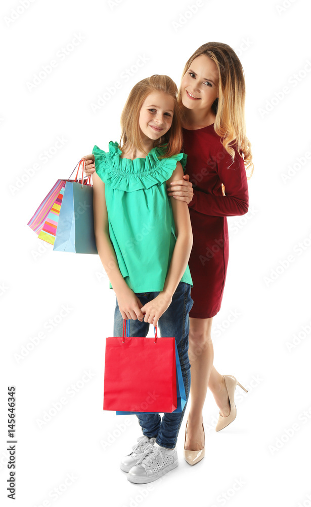 Mother and daughter with paper bags on white background Mother and daughter with paper bags on white background