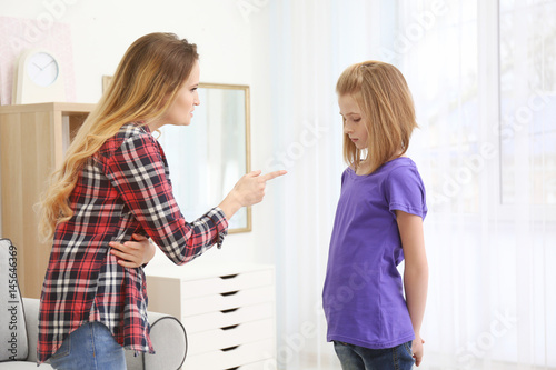 Quarrel between mother and daughter at home photo