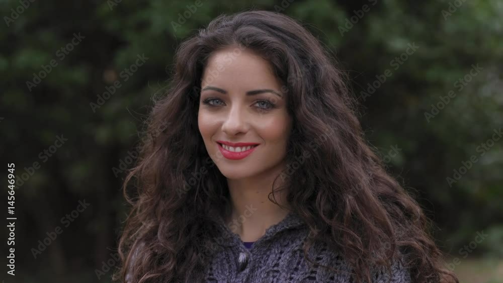 Beautiful young woman turns and smiles at the camera Beautiful young woman turns and smiles at the camera
