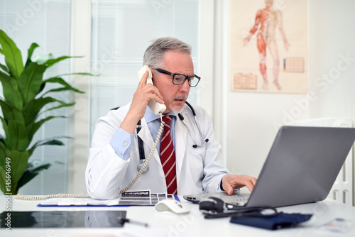 Doctor talking on the phone in his studio