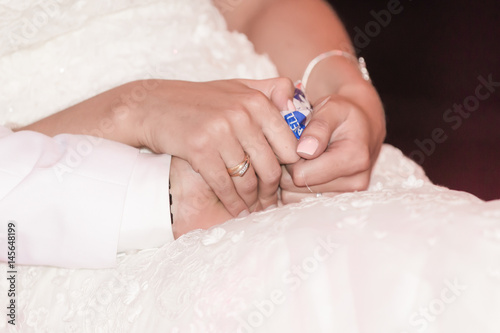 Bride and groom holding hands during wedding ceremony
