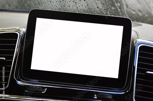 Isolated screen of navigation device inside a car dashboard, with rainy windshield in background