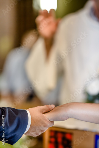 Bride and groom holding hands during wedding ceremony