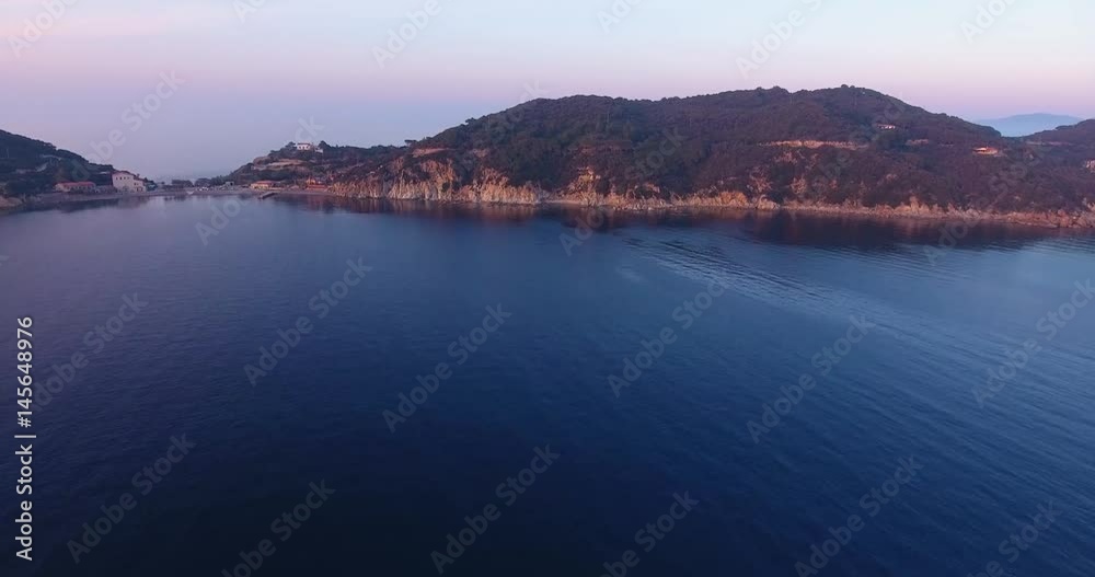 Aerial shot of beautiful sunset on the calm sea in Elba island in Tuscany, Italy, 4K Aerial shot of beautiful sunset on the calm sea in Elba island in Tuscany, Italy, 4K