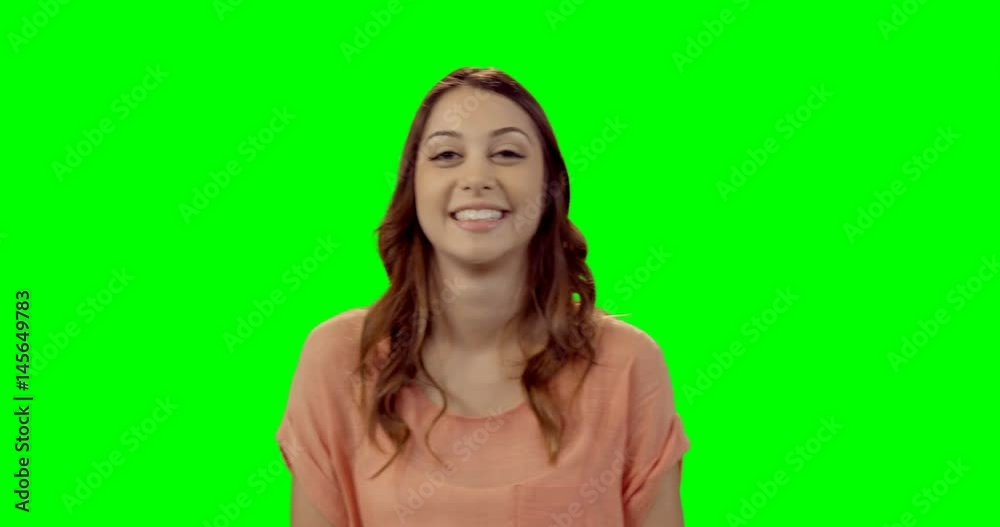 Smiling beautiful woman standing against green screen Smiling beautiful woman standing against green screen