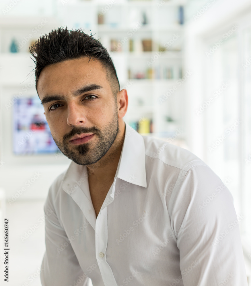 Young confident man at modern home