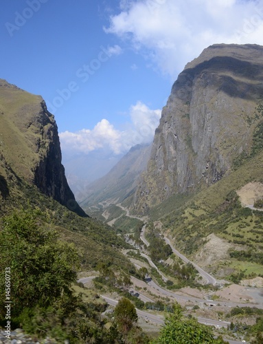 Stunning vertical cliffs towering high above the winding mountain road below. 