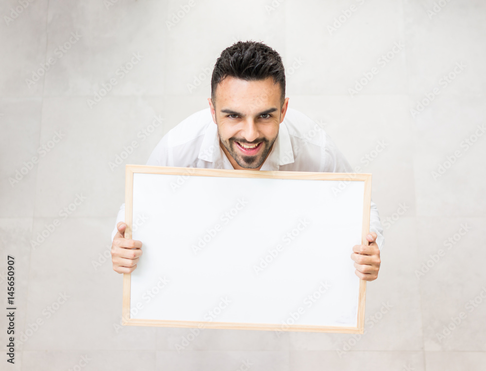 Young confident man with white board copy space for message or text image Young confident man with white board copy space for message or text image