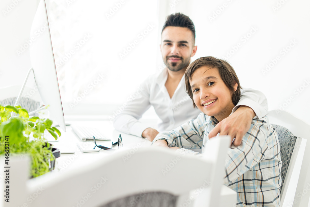 Fototapeta premium Man and boy on computer