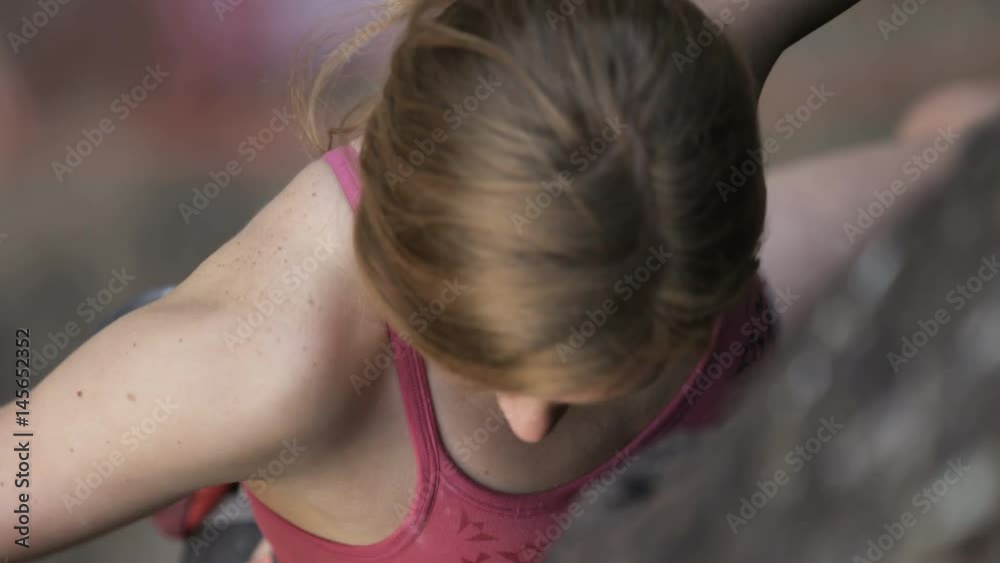 slow motion of girl clipping rope while rock climbing slow motion of girl clipping rope while rock climbing