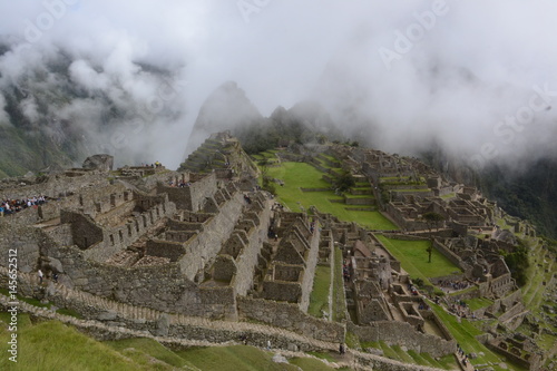 Mist rising to reveal the amazing Machu Picchu ruins nestled high on the ridge line. 