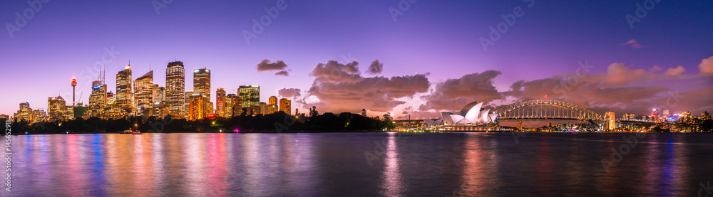 Sydney Opera House and Sydney Harbour Bridge illuminated at dusk
