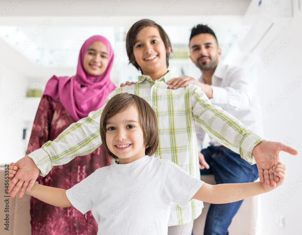 Happy Arabic Muslim family at modern home having fun and good time together Happy Arabic Muslim family at modern home having fun and good time together
