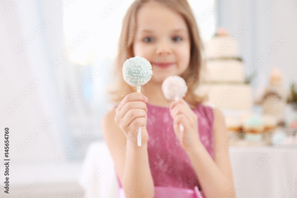 Cute little girl with tasty cake pops at party Cute little girl with tasty cake pops at party