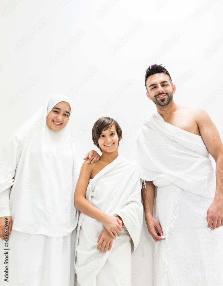 Muslim family posing as ready for Hajj visiting Kaaba in Mecca Muslim family posing as ready for Hajj visiting Kaaba in Mecca