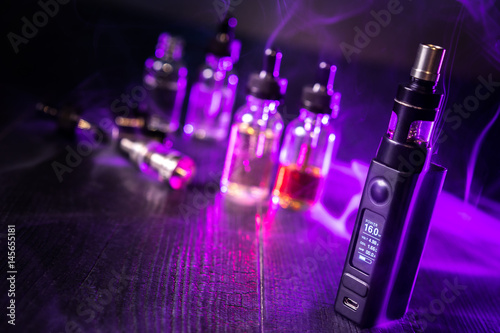 vape, electronic cigarette, on a black background with backlighting and smoke, addiction and harm to health