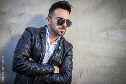 Sexy man posing on grungy wall