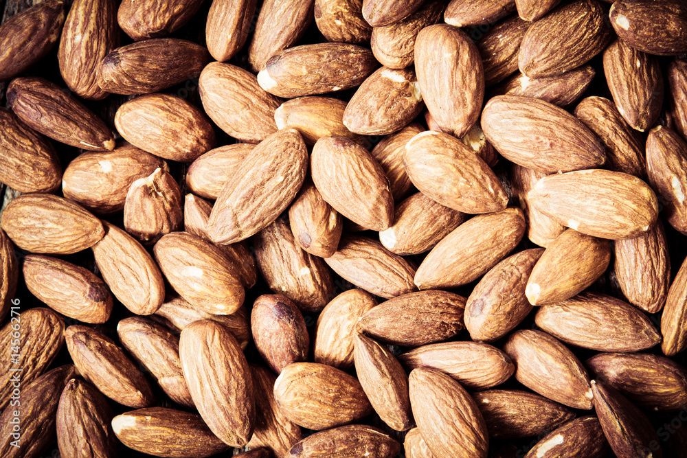 Fototapeta premium close up Peeled almonds nut background