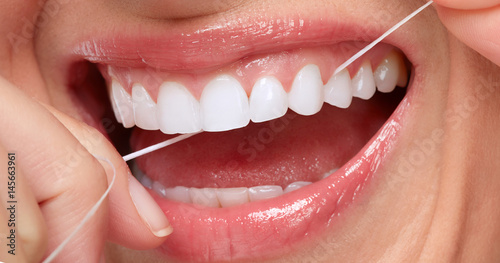 woman smile with tooth floss photo